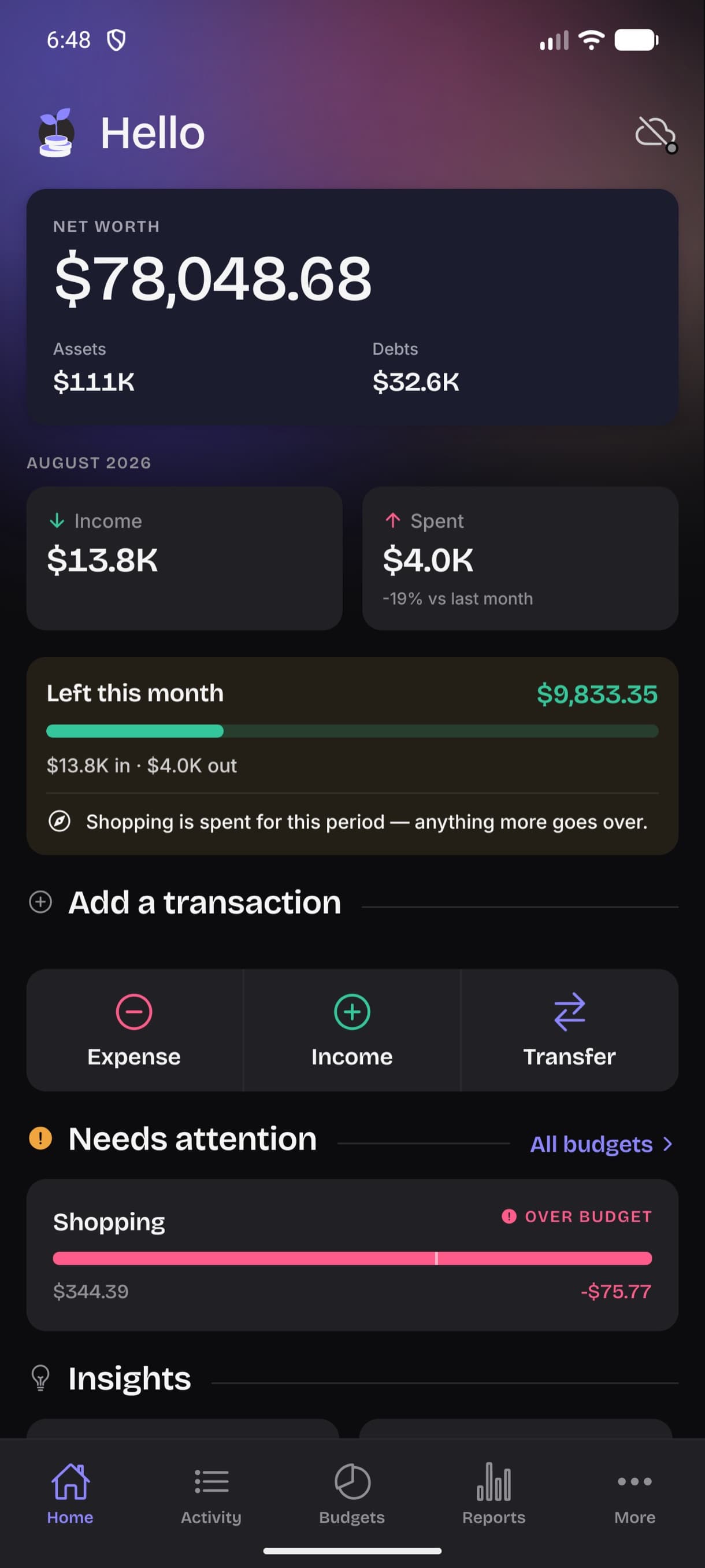 The same home screen in dark mode, with the net worth card, left-to-spend and budget warnings